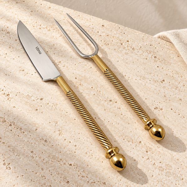 Stainless Steel Carving Set with Gold Accents on a sunlit pale travertine counter