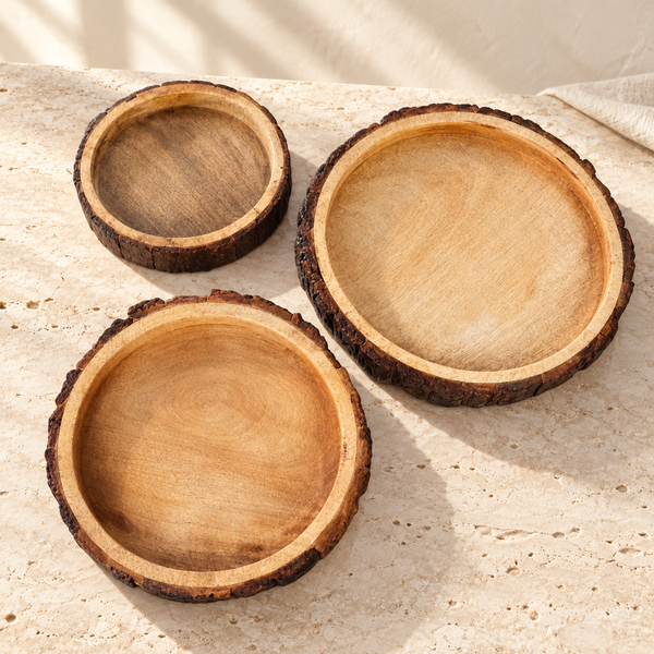 Live-Edge Mango Wood Bark Bowl Set on a sunlit pale travertine counter