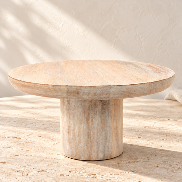 Mango Wood Round Cake Stand on a sunlit pale travertine counter