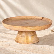 Mango Wood Pedestal Cake Stand on a sunlit pale travertine counter