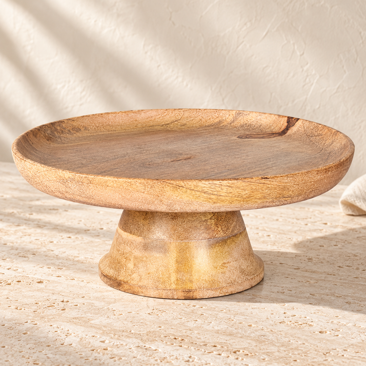 Mango Wood Pedestal Cake Stand on a sunlit pale travertine counter