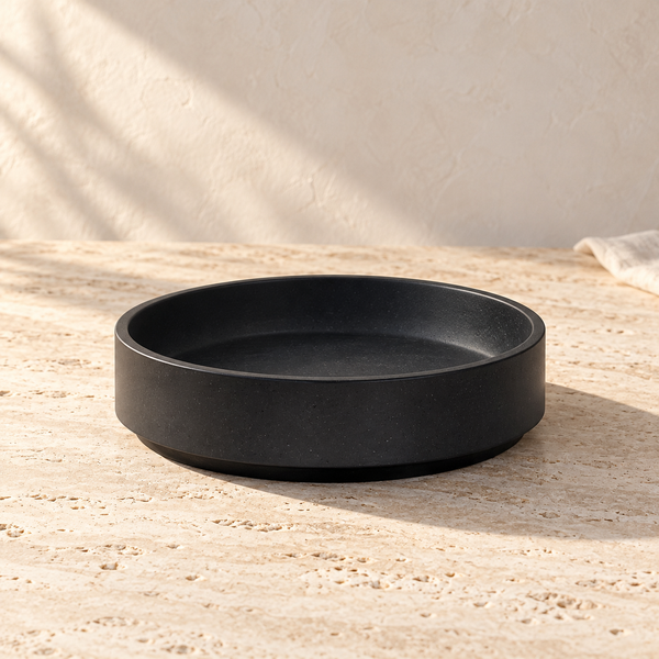 Micro Terrazzo Concrete Round Platter on a sunlit pale travertine counter