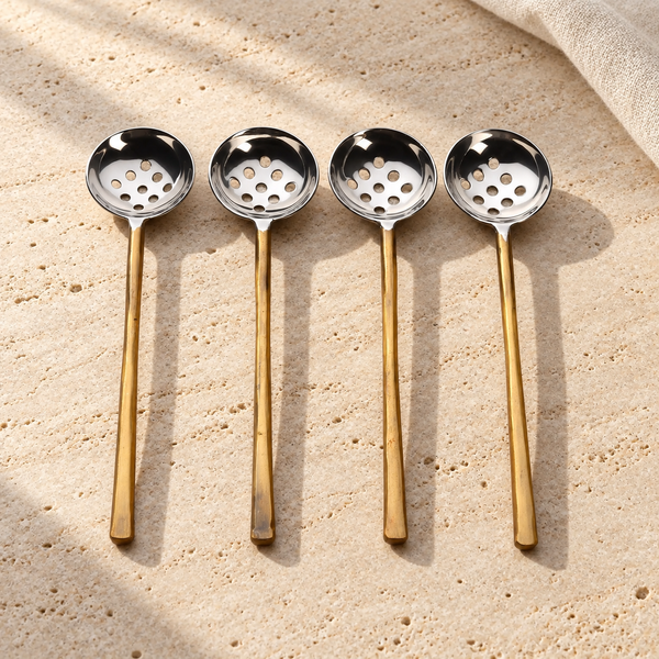 Gold-Tone Perforated Olive Spoon Set on a sunlit pale travertine counter