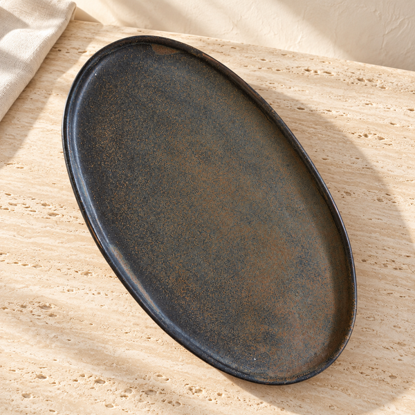 Reactive Glaze Oval Stoneware Platter on a sunlit pale travertine counter
