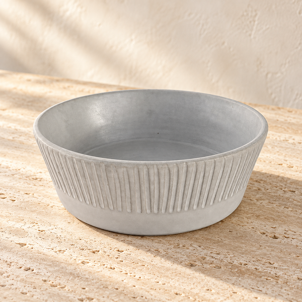 Ribbed Matte Clay Serving Bowl on a sunlit pale travertine counter