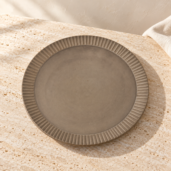 Ridged Ceramic Round Serving Tray on a sunlit pale travertine counter