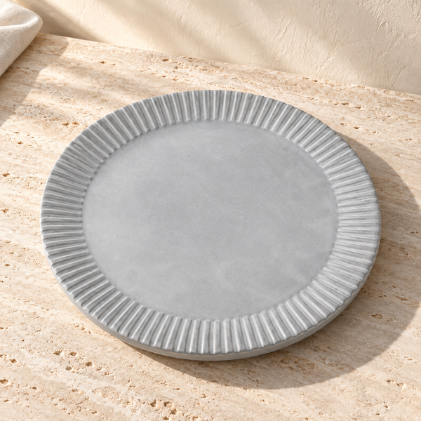 Ridged Stoneware Round Serving Tray on a sunlit pale travertine counter