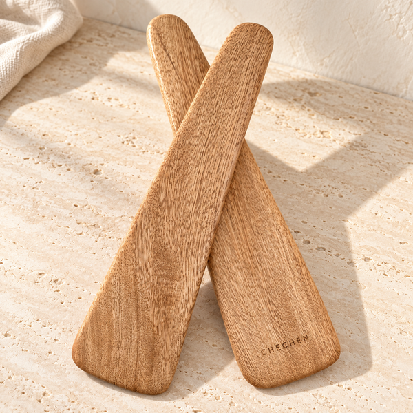 Rosa Morada Wood Salad Servers on a sunlit pale travertine counter