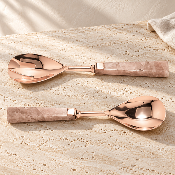 Rose Quartz Handle Salad Server Set on a sunlit pale travertine counter