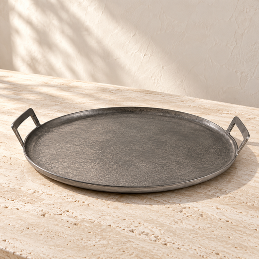 Round Pewter Aluminum Serving Tray on a sunlit pale travertine counter