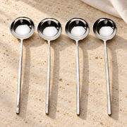 Polished Stainless Steel Sugar Spoon Set on a sunlit pale travertine counter