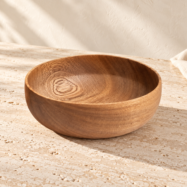 Turned Wood Serving Bowl on a sunlit pale travertine counter