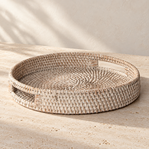 Whitewashed Rattan Round Tray on a sunlit pale travertine counter