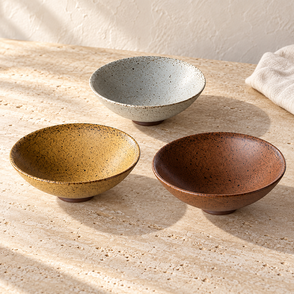 Speckled Matte Ceramic Bowl Set in Set Off 3 on a sunlit travertine counter