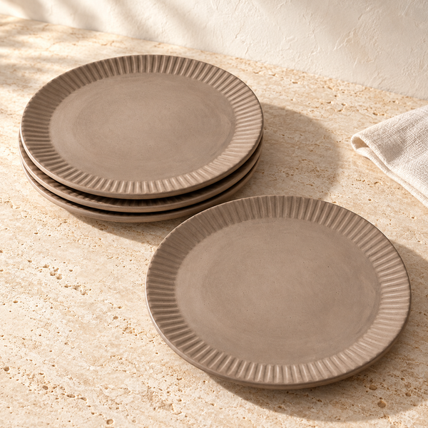 Carved Lines Matte Ceramic Dinner Plates on a sunlit travertine counter