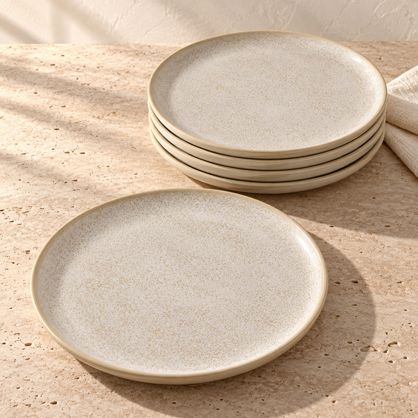 Speckled Ceramic Dinner Plate Set in Latte on a sunlit travertine counter