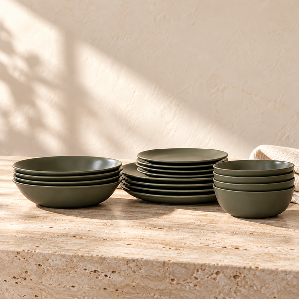 Matte Ceramic Dinnerware Set 16-Piece in Moss on a sunlit travertine counter