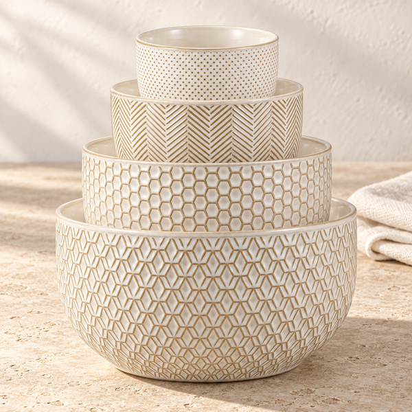 Embossed Stoneware Nesting Bowl Set in Ivory on a sunlit travertine counter