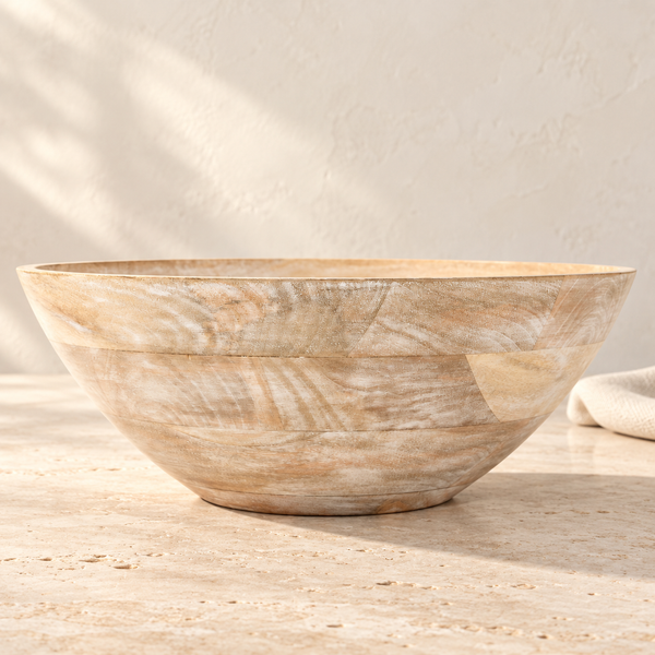 Whitewash Mango Wood Serving Bowl on a sunlit travertine counter