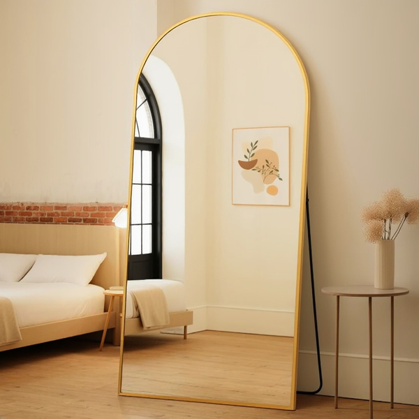 Arched Gold Floor Mirror in a warm editorial loft with natural daylight.
