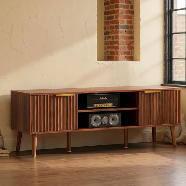 Walnut Fluted TV Stand with Storage & Open Shelves in a warm editorial loft with cream plaster, brick and natural daylight.