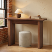 Walnut Fluted Narrow Entryway Console Table in a warm editorial loft with cream plaster, brick and natural daylight