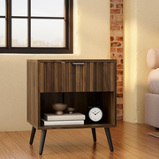 Walnut Fluted Nightstand with Drawer & Open Shelf beside a linen bed in a sunlit loft