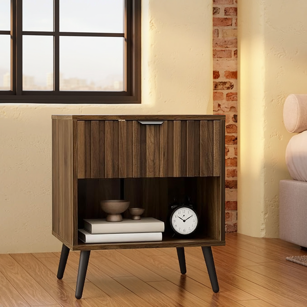 Walnut Fluted Nightstand with Drawer & Open Shelf beside a linen bed in a sunlit loft.