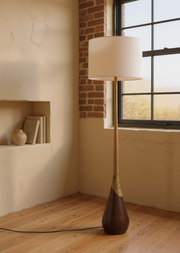 Two-Tone Wood Floor Lamp with White Fabric Shade in a warm editorial loft with natural daylight