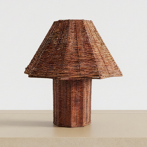 Woven Rattan Table Lamp on a pale concrete tabletop, switched off