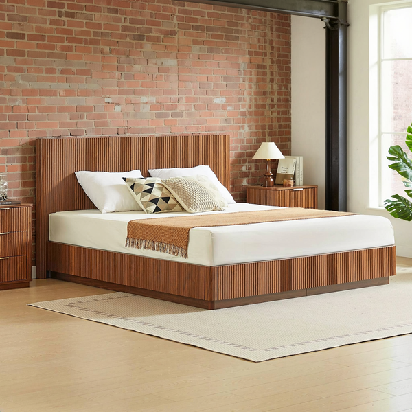 Fluted Walnut-Finish King Bed Frame styled with ivory bedding in a brick and steel loft bedroom with a flat oatmeal rug.