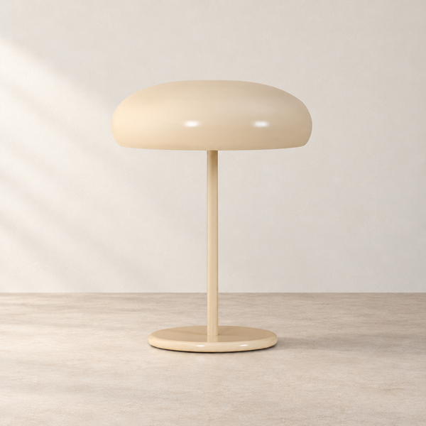 Dome Shade Cream Metal Table Lamp on a warm neutral concrete surface