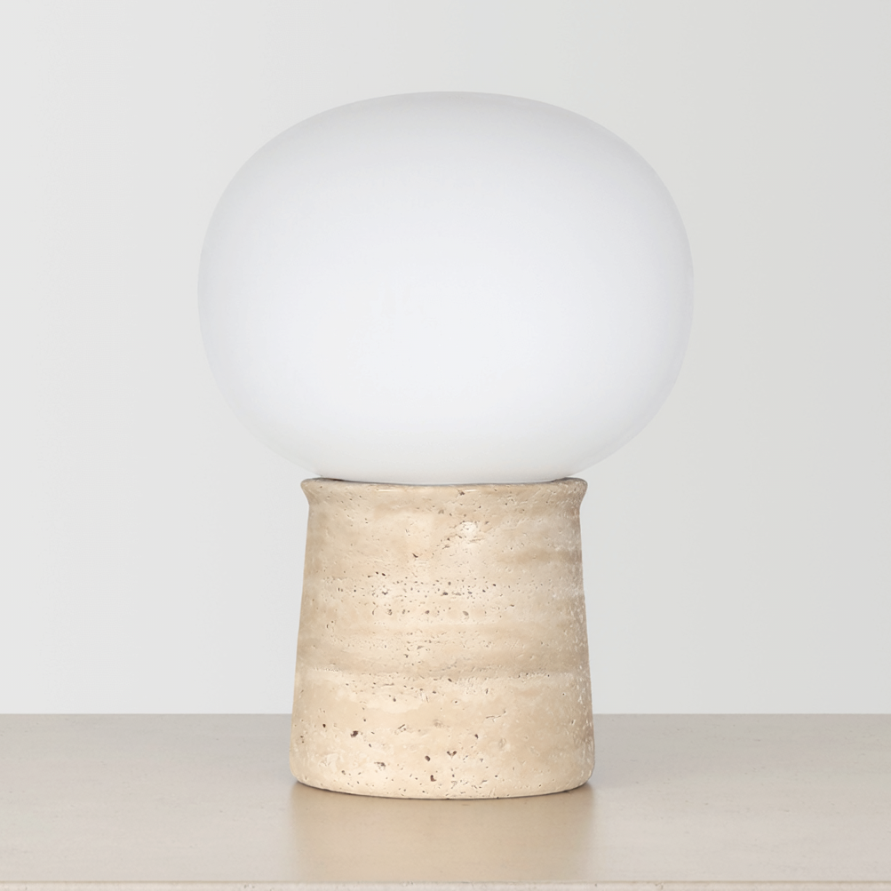 Travertine Globe Table Lamp on a neutral concrete tabletop