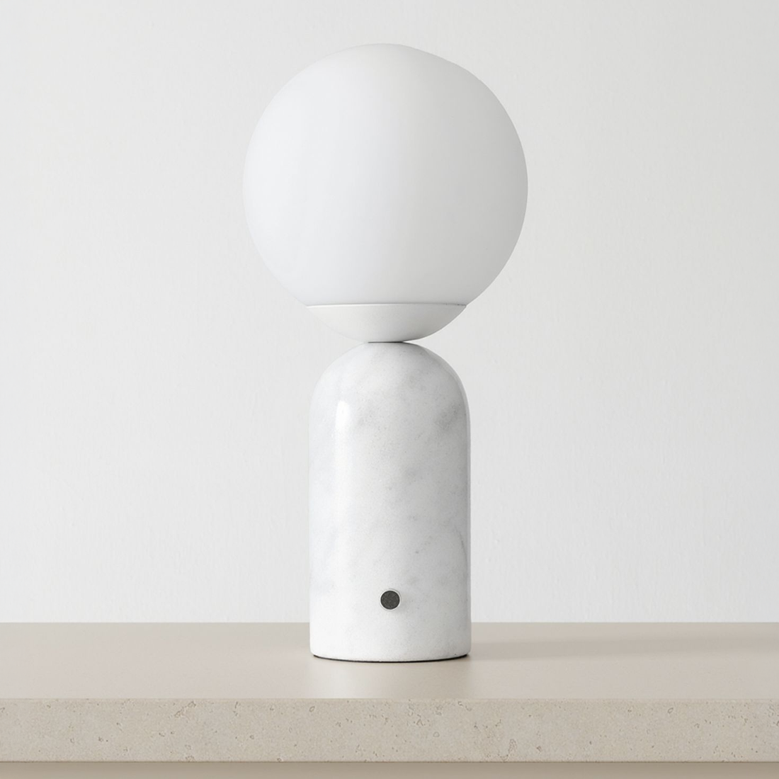 Marble Globe Tall Table Lamp on a neutral concrete tabletop