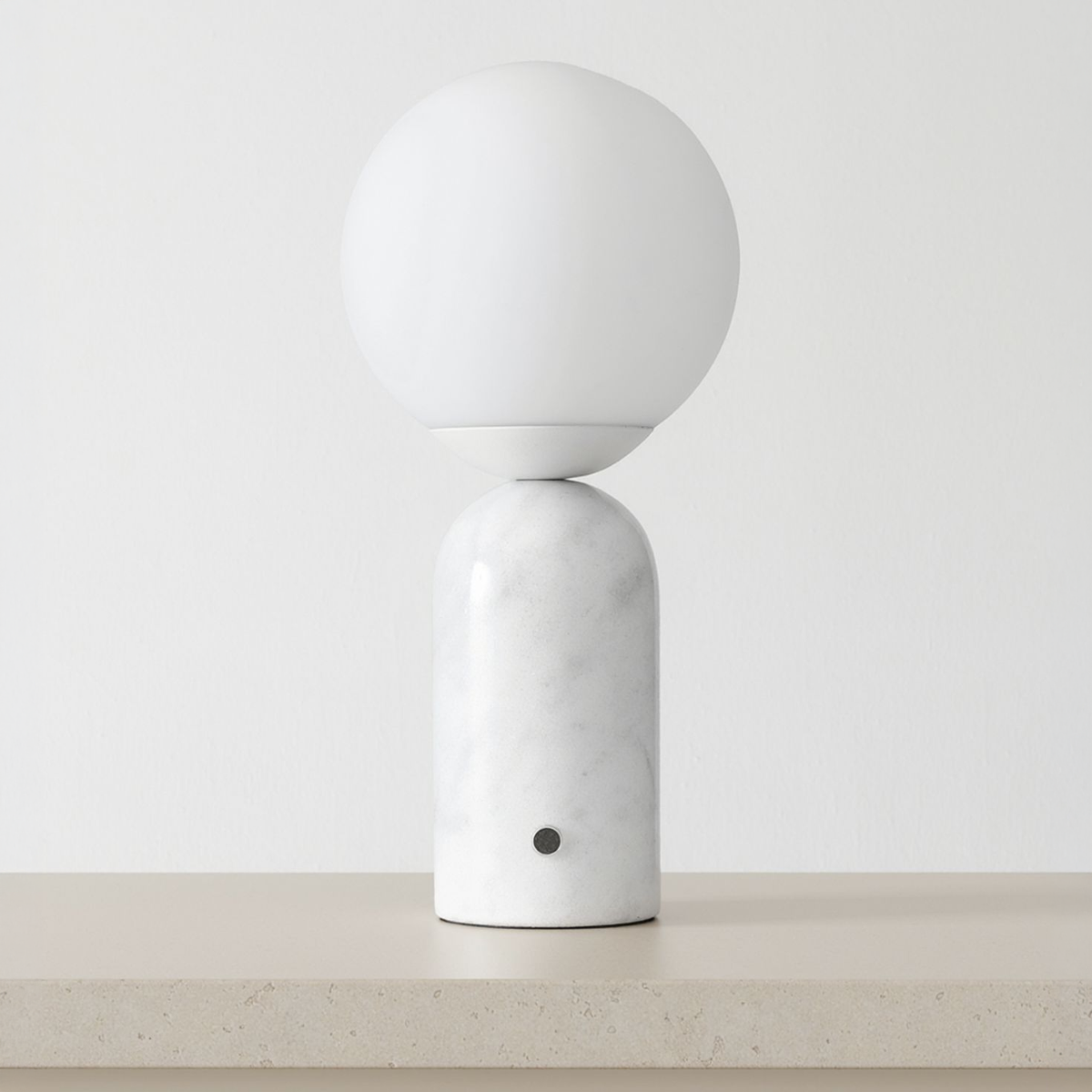 Marble Globe Tall Table Lamp on a neutral concrete tabletop