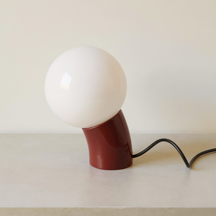 Globe Table Lamp with USB-C Port on a neutral concrete tabletop