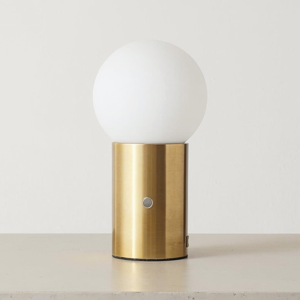 Brass USB Table Lamp with Frosted Glass Globe on a neutral concrete tabletop