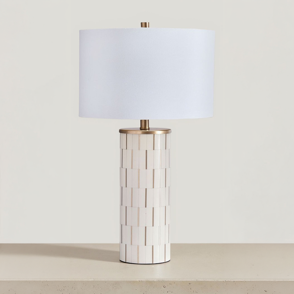 Faridworth - Poly Table Lamp - White / Gold Finish on a neutral concrete tabletop