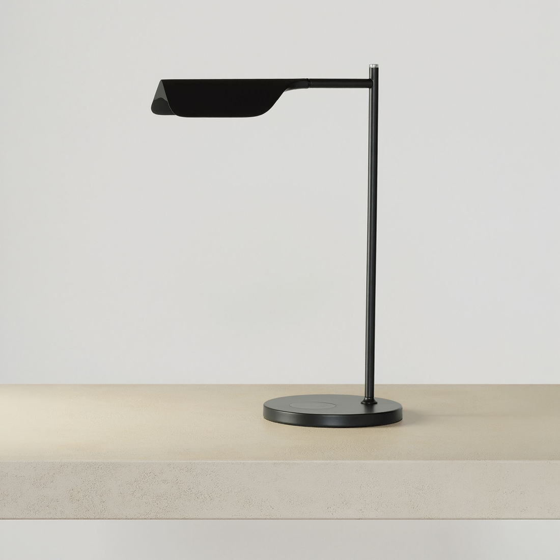 Adjustable Swing Arm Wireless Charging Table Lamp on a neutral concrete tabletop