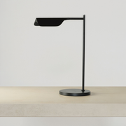 Adjustable Swing Arm Wireless Charging Table Lamp on a neutral concrete tabletop