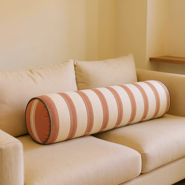 Striped Cotton Bolster Pillow in a close view on coordinated upholstered seating
