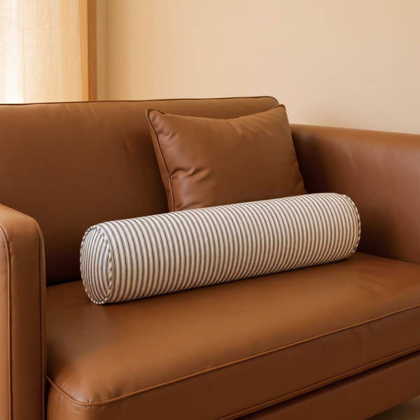 Striped Cotton Bolster Pillow in a close view on coordinated upholstered seating