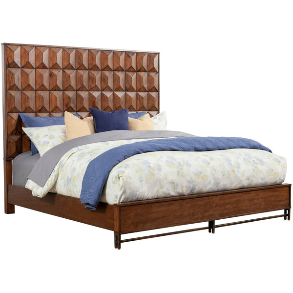 Brown geometric bed with blue and floral bedding viewed diagonally against white.