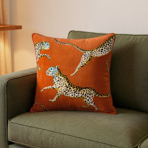Cotton Velvet Leaping Leopard Pillow in a close view on coordinated upholstered seating